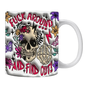 White mug with a large floral skull, a skeletal hand and bold red Fuck Around and Find Out lettering.