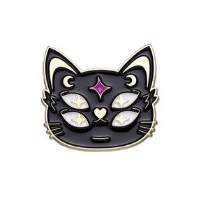 Black cat face enamel pin on white with four pale eyes, crescent moons, fine whiskers and a purple star-shaped forehead accent.