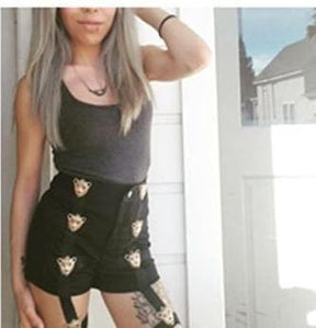 Black garter shorts with embroidered cat faces featuring belts built for a stylish edgy look