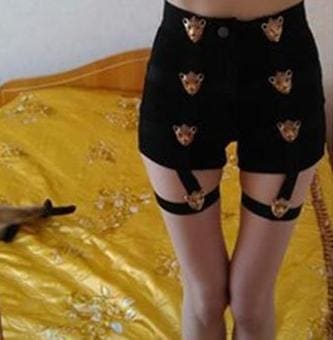 Black garter shorts with gold tiger head embellishments and belts built for edgy style and fit