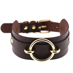 Dark brown vegan leather choker necklace with a golden o-ring centerpiece and matching metallic hardware perfect for edgy looks