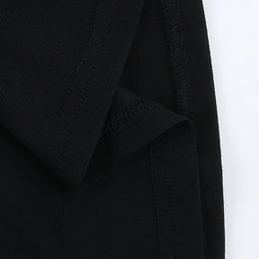 Inside lower edge of the black T-shirt, showing stitching where the mesh panel meets the hem.
