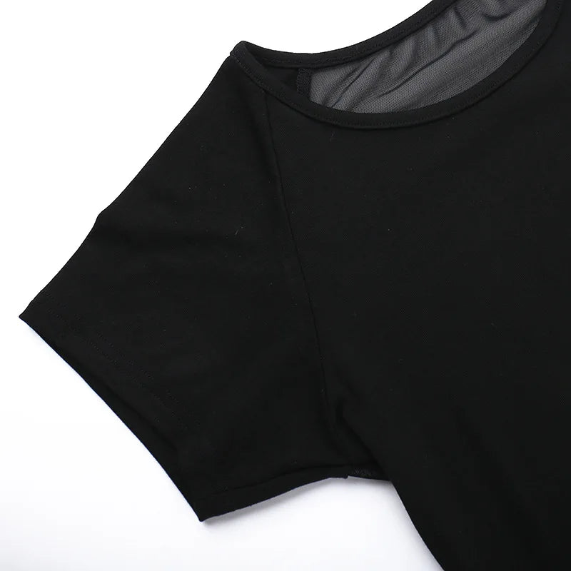Detail of the black short sleeve, shoulder and neckline seams laid on white.