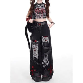 Relaxed front view of washed black gothic wide-leg jeans, showing the front pockets and contrasting cross designs.