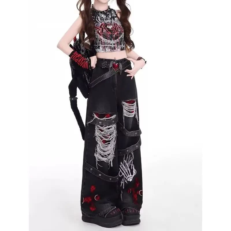Model wearing black wide-leg gothic jeans with heavy fraying and red cross details, styled with a cropped top.