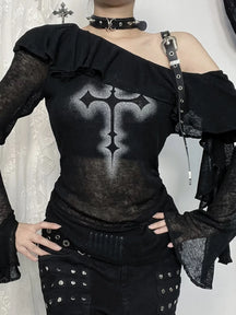 Close front view of cross print, shoulder buckle and ruffle neckline