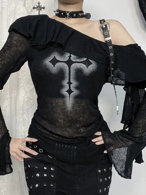 Close front view of cross print, shoulder buckle and ruffle neckline