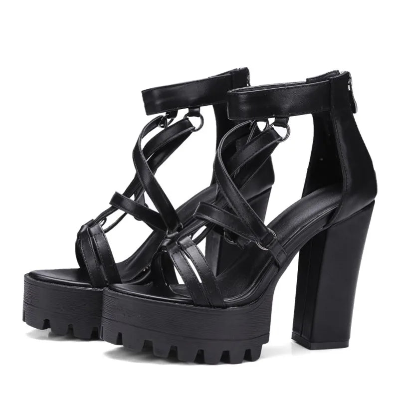 Pair of black cross-strap gothic platform sandals on white background