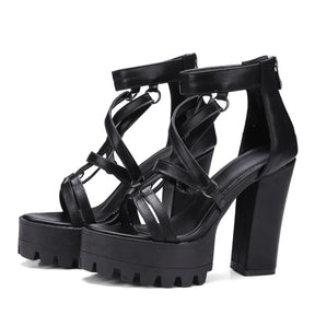 Pair of black gothic sandals with ring-linked straps and open toes