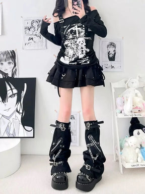 Full outfit view of black buckle and chain leg warmers with a graphic top, short skirt and platform footwear.