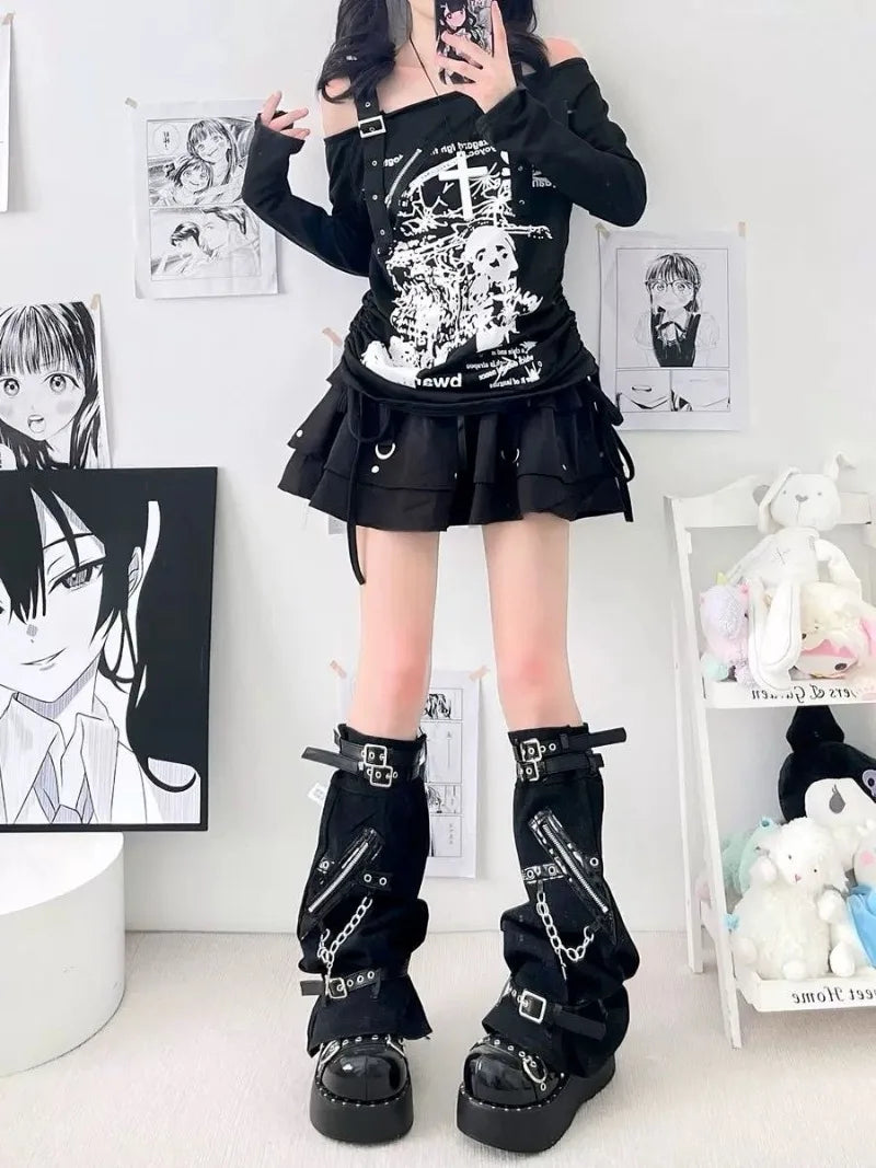 Full outfit view of black buckle and chain leg warmers with a graphic top, short skirt and platform footwear.