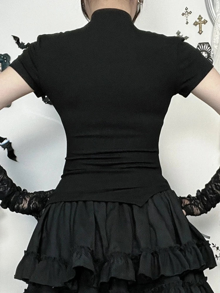 Back view of the plain black T-shirt, showing short sleeves and a fitted waist above a tiered skirt.