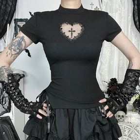 Black heart-cutout cross T-shirt shown with hands at the waist and a ruffled skirt, highlighting its slim shape.