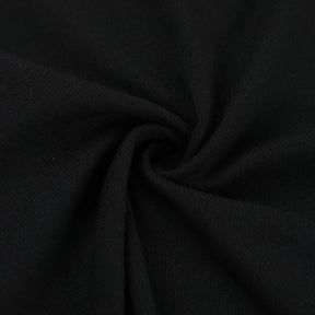 Close-up of the black T-shirt fabric folded into a small gathered swirl.