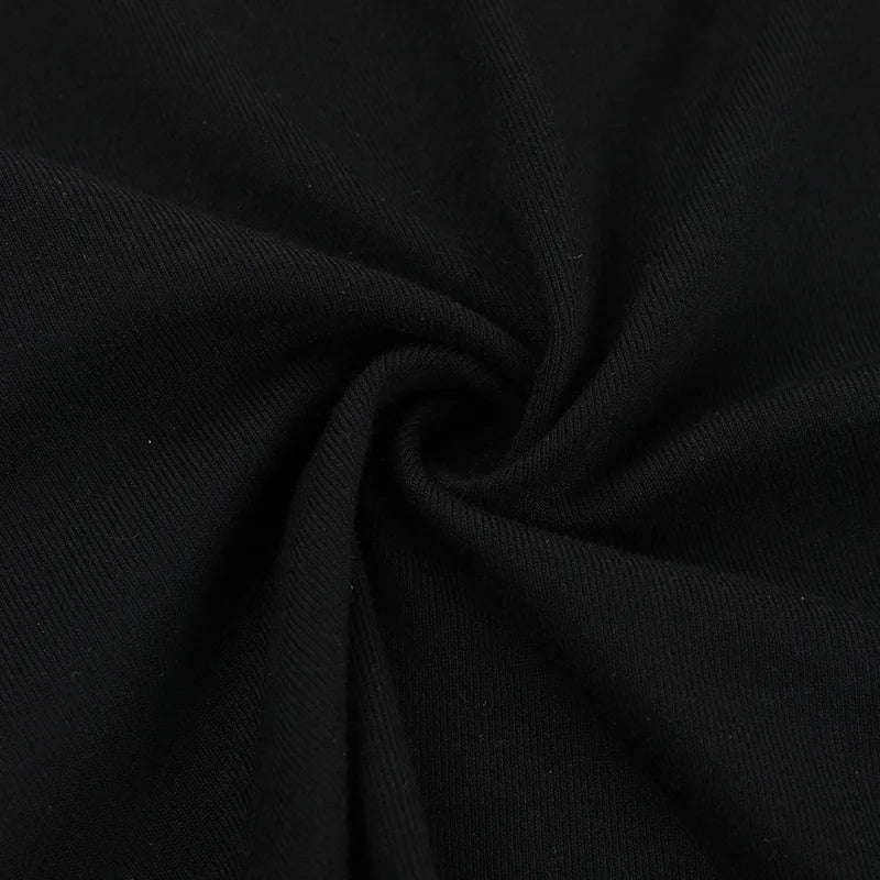 Close-up of the black T-shirt fabric folded into a small gathered swirl.