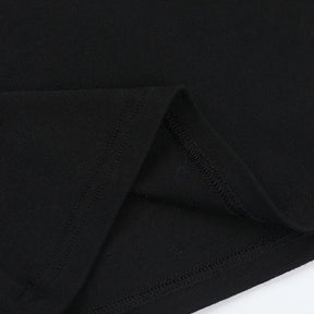 Inside seam detail of the black heart-cutout T-shirt, with the fabric folded back to show stitching.