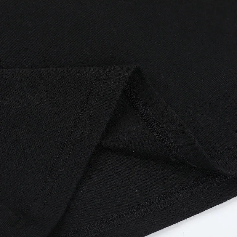Inside seam detail of the black heart-cutout T-shirt, with the fabric folded back to show stitching.