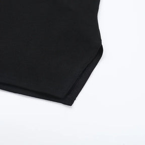 Lower corner of the black T-shirt laid flat, showing its shaped hem and stitched edge.