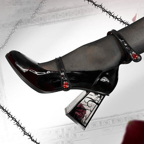 Full side profile of a glossy wine-red Mary Jane against a decorative frame, with red jewel accents, rounded toe and transparent rose-filled block heel.