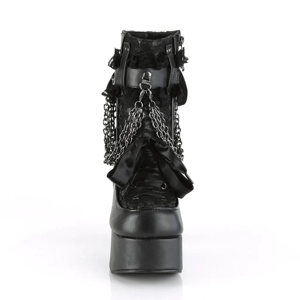 Straight-on front view of a black gothic platform boot with ribbon lacing, a bow and round toe.