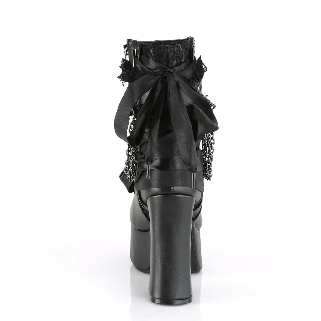 Back view of a black platform ankle boot with an oversized bow above the chunky heel.