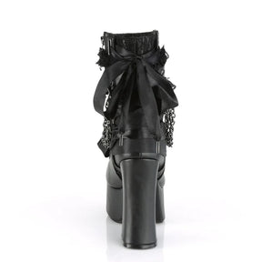 Back view of a black platform ankle boot with an oversized bow above the chunky heel.