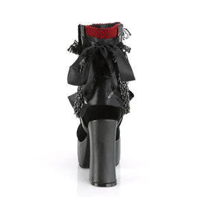 Rear view of a red gothic platform boot with a large black bow and red lace-trimmed cuff.