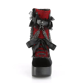 Front view of a red gothic platform boot showing black ribbon lacing, lace texture and a rounded toe.