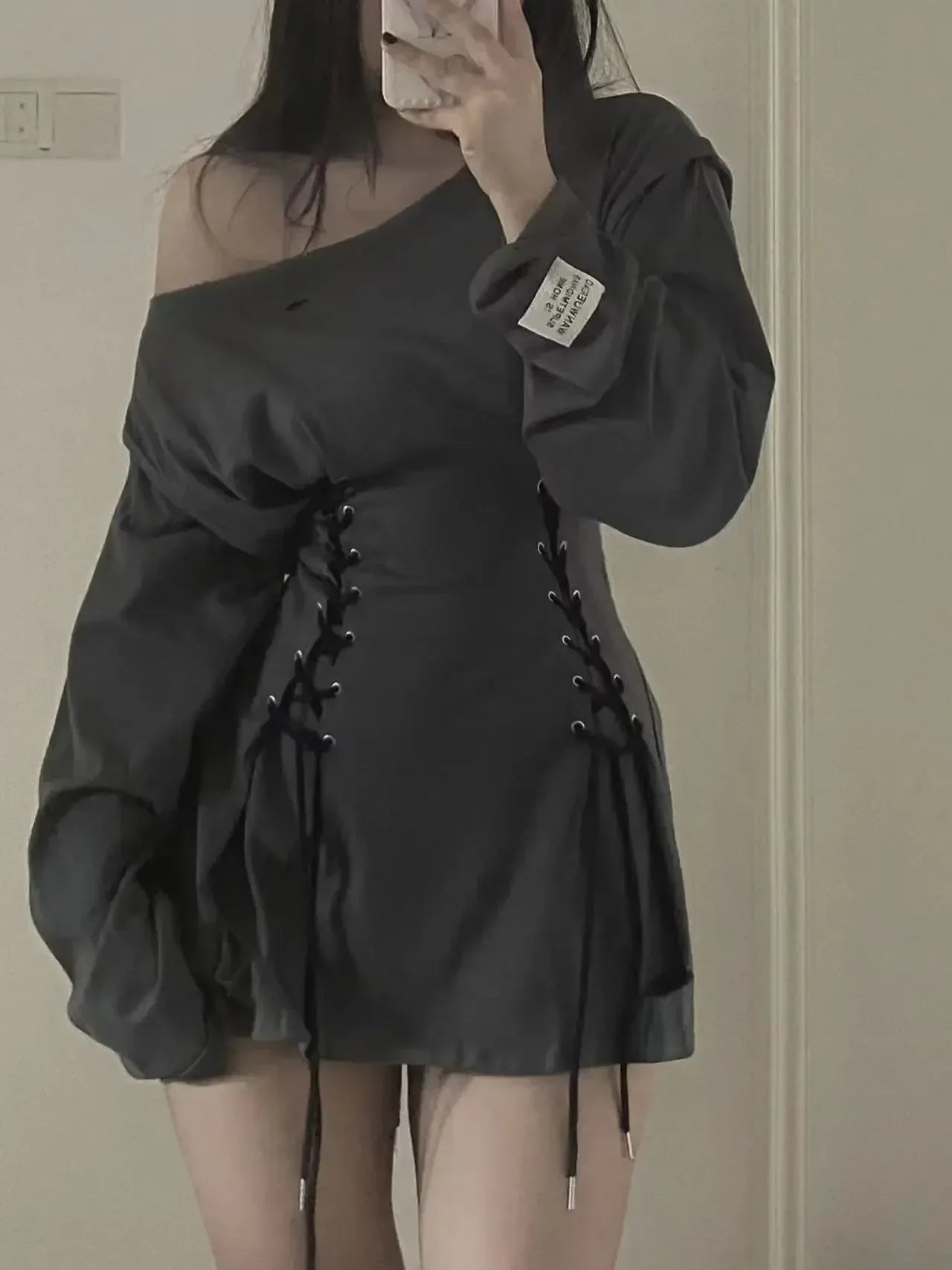 Mirror photo showing the laced waist of a gray grunge mini dress
