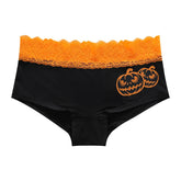 Black briefs with two smiling orange jack-o'-lanterns and a wide orange lace waistband.