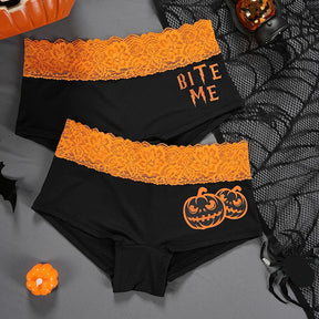 Bite Me and jack-o'-lantern briefs arranged together with orange floral-lace waistbands.