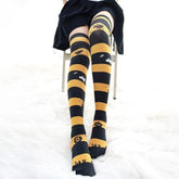 Creepy cute black and yellow halloween striped thigh high stockings with witches ghosts pumpkins and bats designs