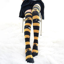 Creepy cute black and yellow halloween striped thigh high stockings with witches ghosts pumpkins and bats designs