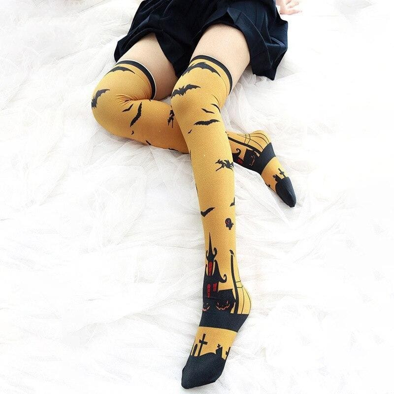 Yellow creepy cute thigh high stockings with black bat and haunted house prints perfect for halloween fun