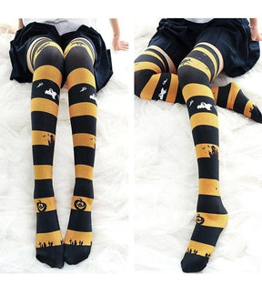 Creepy cute black and yellow striped halloween thigh high stockings with ghost pumpkin and graveyard motifs