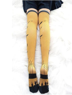 Yellow thigh high stockings with creepy cute black bird silhouettes and graveyard design with elasticated cuffs
