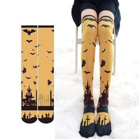Yellow and black creepy cute thigh high stockings with bats haunted houses and graveyard motifs for halloween fun