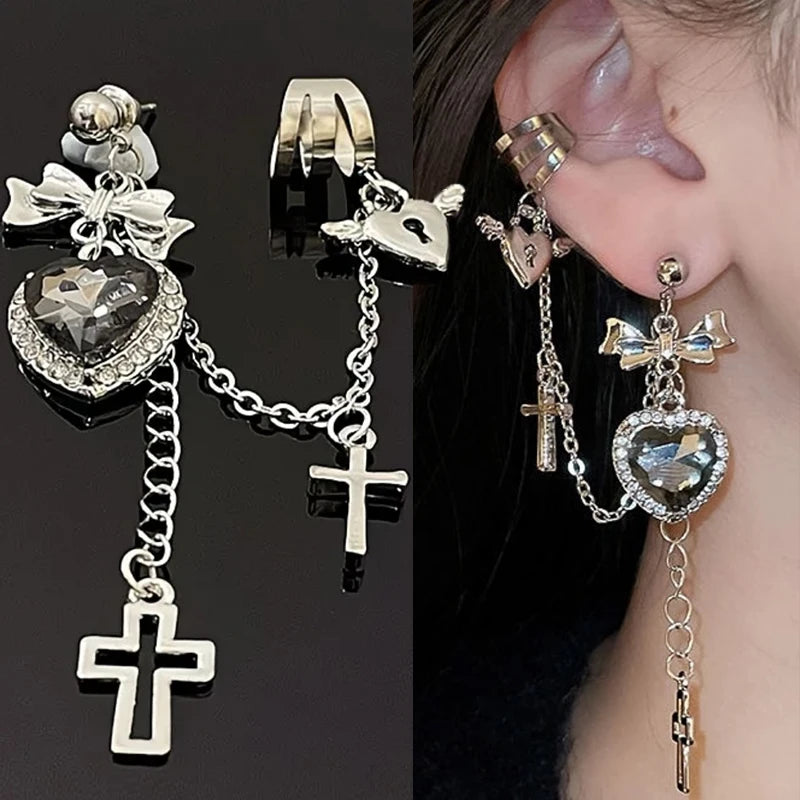 Two-panel view of a faceted heart chain earring against black and the same style worn on an ear. The bow, upper-ear cuff and long cross drops are visible together.