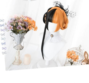 Long split halloween lolita wig with black and orange two toned cosplay style and a cute polka dot bow accessory