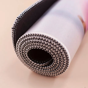 Rolled mousepad construction sample showing its flexible layers and stitched edge in close-up; the spirit board artwork is not visible in this view.