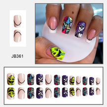 Pink square nails with neon-green and purple character graphics, contrasting black details and patterned tips, shown on a hand and in rows.