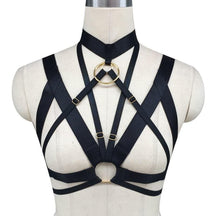 Black satin o-ring chest harness with gold-toned metal rings and adjustable buckles for a sleek chest harness look