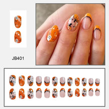 Orange and pink pointed Halloween nails with pumpkin, ghost and spiderweb artwork, shown worn beside matching nail tips.