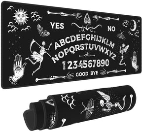 Black Ouija spirit board mousepad displayed flat and rolled, with white alphabet rows, numbers, skeletons, moths, a sun face and crescent moon framed by stitched edges.