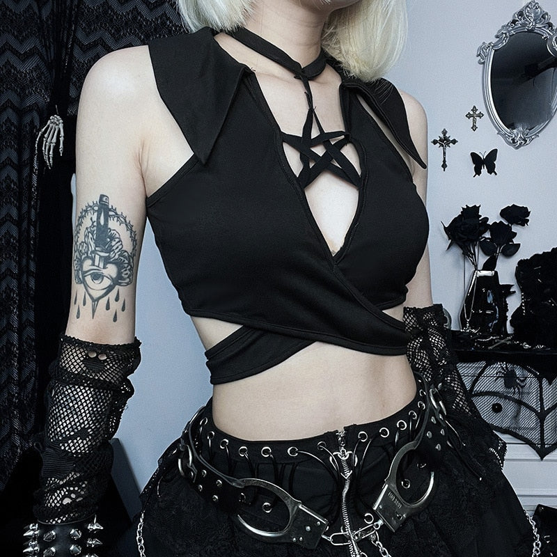 Angled view of the black pentagram wrap crop top, showing its layered front panels and open side above the waist band.