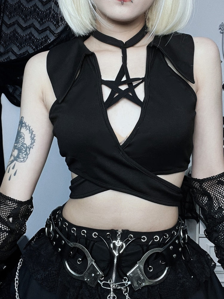 Front view of a black pentagram crop top, showing the star straps, pointed collar details and broad panels crossing at the waist.