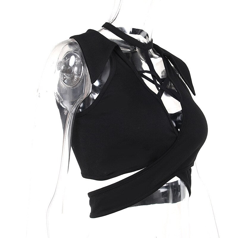 Side-angle mannequin view of the black wrap crop top, with star straps above the front and a broad lower band around the waist.
