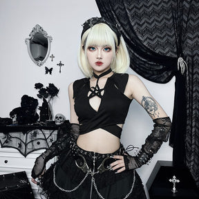 Front outfit view of the sleeveless pentagram wrap top worn above a black skirt with silver-tone chains and buckles.