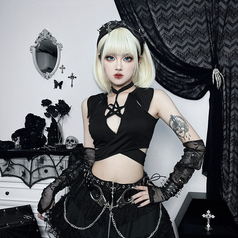 Front outfit view of the sleeveless pentagram wrap top worn above a black skirt with silver-tone chains and buckles.