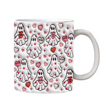 White mug covered in small ghosts carrying pink hearts, with pink and red heart details between them.